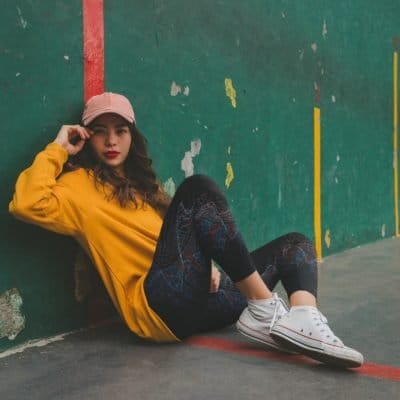 mockup-of-a-girl-wearing-big-fractal-yoga-leggings-sitting-on-the-floor-against-a-green-wall mockup-of-a-girl-wearing-big-fractal-yoga-leggings-sitting-on-the-floor-against-a-green-wall
